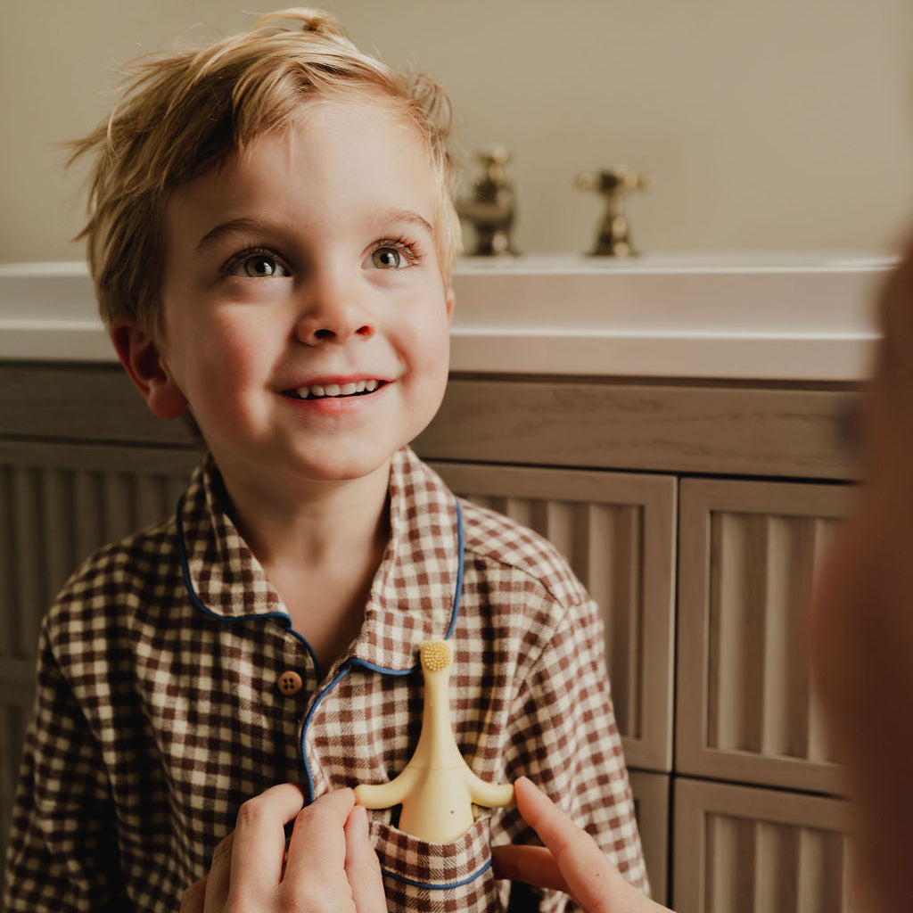 Brushi Bear™ by Little Brushies electric toothbrush with little boy in the bathroom