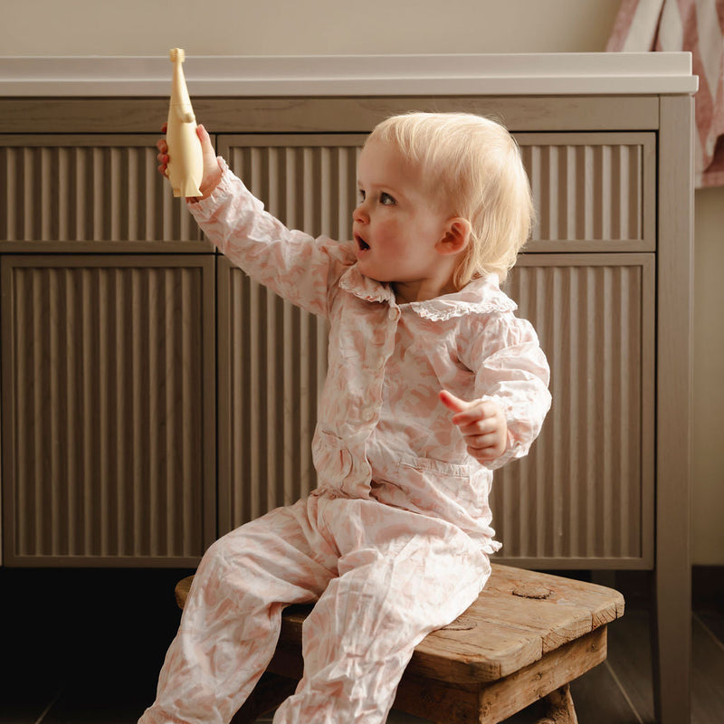 Baby in bathroom with Brushi Bear electric toothbrush 
