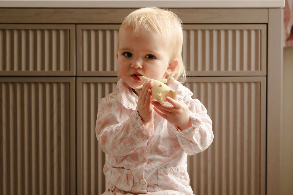 toddler brushing teeth in bathroom 