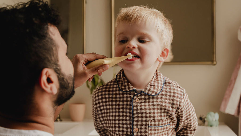 Dad & Son brushing teeth in the bathroom with Brushi Bear electric toothebrush